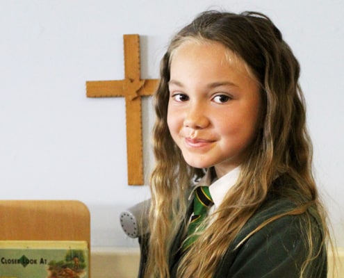 Christ Church girl uniform cross in background